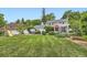 A spacious backyard featuring a hot tub, playground, patio area, and manicured lawn at 1000 N Monaco Pkwy, Denver, CO 80220