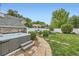 The backyard features a hot tub, stone pathway, green lawn, and privacy fence at 1000 N Monaco Pkwy, Denver, CO 80220