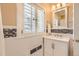 Bright bathroom featuring white subway tile, decorative accent tile, and updated fixtures at 1000 N Monaco Pkwy, Denver, CO 80220