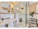Updated bathroom with a glass-enclosed shower, pedestal sink, and modern finishes at 1000 N Monaco Pkwy, Denver, CO 80220