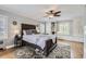 Inviting bedroom with hardwood floors, ceiling fan, and built-in shelving and window seat at 1000 N Monaco Pkwy, Denver, CO 80220
