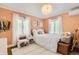 Cozy bedroom with natural light, wood floors, and simple decor at 1000 N Monaco Pkwy, Denver, CO 80220