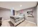 Inviting bedroom showcasing plush carpet, neutral walls, and soft, patterned bedding at 1000 N Monaco Pkwy, Denver, CO 80220