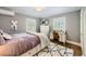 Cozy bedroom featuring hardwood floors, a decorative rug, and a functional writing desk at 1000 N Monaco Pkwy, Denver, CO 80220