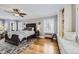 Comfortable bedroom with ceiling fan, hardwood floors, and built-in window seat with storage at 1000 N Monaco Pkwy, Denver, CO 80220