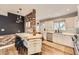 Bright kitchen featuring stainless steel appliances, white cabinets, brick accent wall, and ample counter space for meal prep at 1000 N Monaco Pkwy, Denver, CO 80220