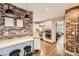 Modern kitchen featuring stainless steel appliances, a brick accent wall, and an eat-in island, perfect for cooking at 1000 N Monaco Pkwy, Denver, CO 80220