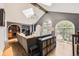 Inviting living room features vaulted ceiling with wood beams and arched windows offering ample natural light at 1000 N Monaco Pkwy, Denver, CO 80220