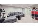 Finished basement with workout equipment, a sectional couch, and minimalist decor at 1000 N Monaco Pkwy, Denver, CO 80220