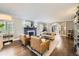 Inviting living room with a cozy fireplace and two tan leather chairs, perfect for relaxing and entertaining guests at 1000 N Monaco Pkwy, Denver, CO 80220