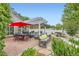 Outdoor patio with pergola, stone water feature, and outdoor dining and lounging areas at 1000 N Monaco Pkwy, Denver, CO 80220