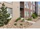 Modern building exterior featuring a manicured landscape, stone accents, and multiple units at 8475 E 36Th Ave # 131, Denver, CO 80238