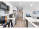 Bright kitchen with modern appliances, sleek countertops, and ample cabinet space at 8475 E 36Th Ave # 131, Denver, CO 80238