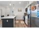 Well-lit kitchen featuring a spacious island, modern appliances, and hardwood flooring at 8475 E 36Th Ave # 131, Denver, CO 80238