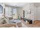 Bright living room with a couch, entertainment center, and access to a balcony with outside views at 8475 E 36Th Ave # 131, Denver, CO 80238