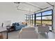 Relaxing living room with modern decor and expansive garage door windows offering abundant natural light at 8475 E 36Th Ave # 131, Denver, CO 80238