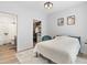 Bright main bedroom with closet and bathroom access, with hardwood flooring and modern finishes at 8475 E 36Th Ave # 131, Denver, CO 80238