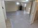 Spacious basement area with painted concrete floors, mini fridge, and a bright window at 3540 Niagara St, Denver, CO 80207