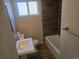 Bright bathroom featuring neutral paint, decorative backsplash, and tiled shower at 3540 Niagara St, Denver, CO 80207