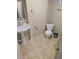 Powder room features a pedestal sink, and a toilet, complemented by stone floors at 3540 Niagara St, Denver, CO 80207