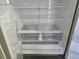 A clean refrigerator interior with adjustable shelves and clear storage drawers provides ample storage at 3540 Niagara St, Denver, CO 80207