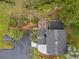 Stunning aerial view of home with landscaped yard, deck, stream and mature trees at 5071 Parmalee Gulch Rd, Indian Hills, CO 80454