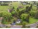 Aerial view of house on a hill with trees and landscaping at 5071 Parmalee Gulch Rd, Indian Hills, CO 80454