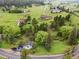 Aerial view of house on a hill with beautiful natural trees and landscaping at 5071 Parmalee Gulch Rd, Indian Hills, CO 80454