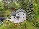Aerial view of home boasting fresh landscaping and mature trees at 5071 Parmalee Gulch Rd, Indian Hills, CO 80454