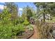 The beautiful backyard boasts natural landscaping and a lovely deck at 5071 Parmalee Gulch Rd, Indian Hills, CO 80454
