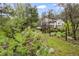 The beautiful backyard has a scenic creek and established trees at 5071 Parmalee Gulch Rd, Indian Hills, CO 80454