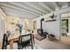 Bright dining area boasts a cozy wood stove and a stylish table set for six at 5071 Parmalee Gulch Rd, Indian Hills, CO 80454