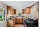 Kitchen featuring granite countertops, updated cabinets and modern gas range at 5071 Parmalee Gulch Rd, Indian Hills, CO 80454