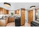 Charming kitchen featuring modern appliances, cabinetry and wood flooring at 5071 Parmalee Gulch Rd, Indian Hills, CO 80454
