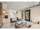 Cozy living room with open staircase, sliding doors to patio, and comfortable seating at 5071 Parmalee Gulch Rd, Indian Hills, CO 80454