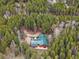 Secluded mountain home with green metal roof nestled in a dense forest offering privacy and scenic views at 9123 Booker Ln, Conifer, CO 80433