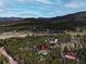 High altitude view of a mountain home among tall trees with picturesque mountain views in the background at 9123 Booker Ln, Conifer, CO 80433