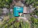 Aerial view of the home highlighting the roof and mature trees at 9123 Booker Ln, Conifer, CO 80433