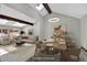 Staged dining and living area featuring modern decor, skylights, and ample natural light at 9123 Booker Ln, Conifer, CO 80433