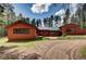 Rustic home with a metal roof and a large yard backing onto a forest at 9123 Booker Ln, Conifer, CO 80433
