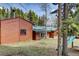 Exterior showing wood siding, large windows, and a playset at 9123 Booker Ln, Conifer, CO 80433