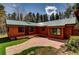 Charming exterior of home with wood siding, a green metal roof, and a stone pathway at 9123 Booker Ln, Conifer, CO 80433