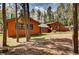 Exterior view of home featuring wood siding and a green metal roof amongst the trees at 9123 Booker Ln, Conifer, CO 80433