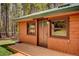 Close up of home featuring wood siding, a green metal roof, and a front door entrance at 9123 Booker Ln, Conifer, CO 80433