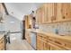 Bright kitchen featuring wood cabinets, stainless steel appliances, and a stylish backsplash at 9123 Booker Ln, Conifer, CO 80433