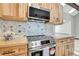 Contemporary kitchen with stainless steel appliances, light wood cabinets and butcher block countertops at 9123 Booker Ln, Conifer, CO 80433
