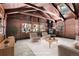 Living room featuring wood paneled walls, a vaulted ceiling, and a stunning wood burning stove at 9123 Booker Ln, Conifer, CO 80433