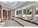 Bright sunroom with large windows, skylights, and a built-in bench showcasing forest views at 9123 Booker Ln, Conifer, CO 80433