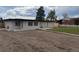 Home exterior showcasing a neutral palette, windows, and freshly prepared dirt plot for landscaping at 9950 W 17Th Ave, Lakewood, CO 80215