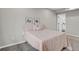 Cozy bedroom with plush carpet and soft pink bedding creating a relaxing atmosphere at 9950 W 17Th Ave, Lakewood, CO 80215